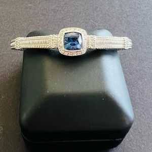 Judith Ripka silver bangle with ‘sapphire’ colored CZ stone.